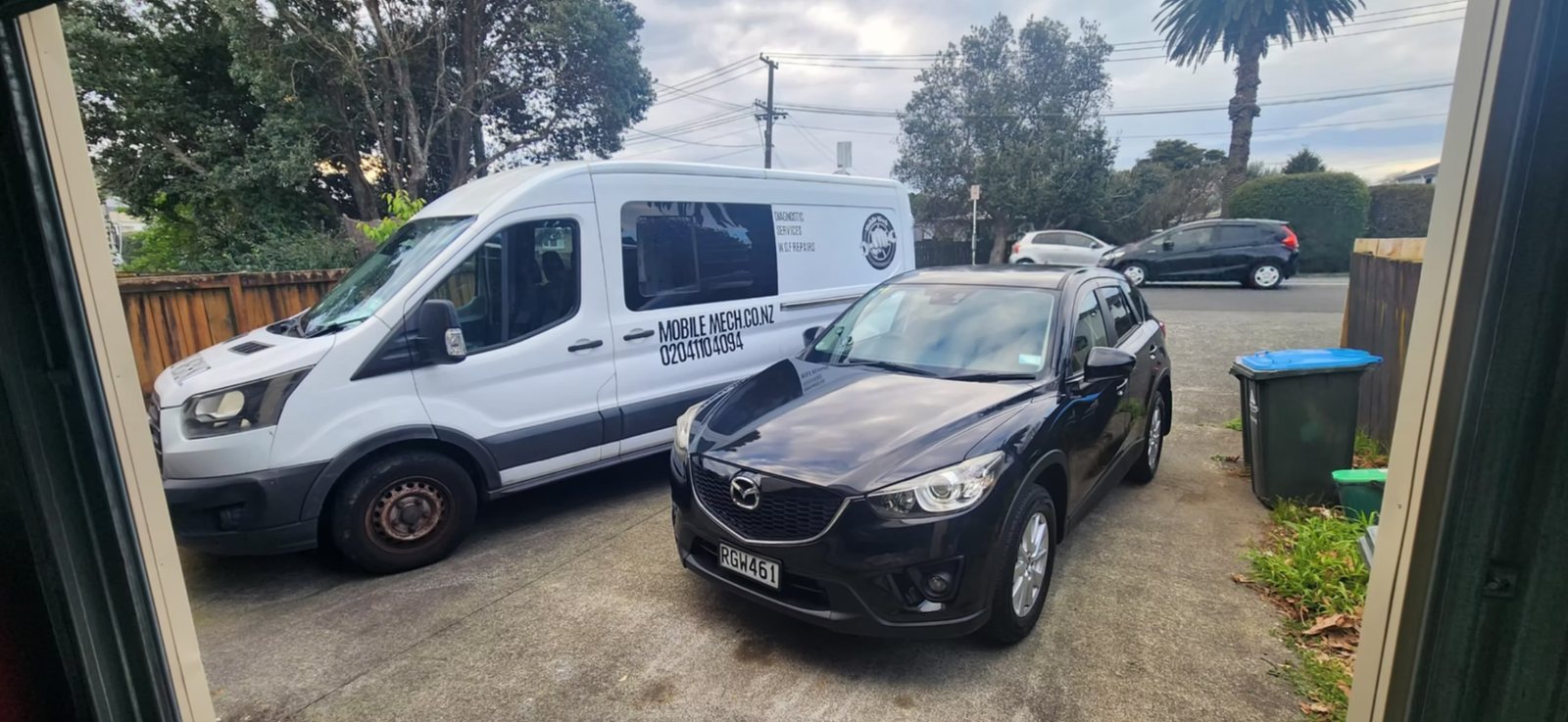Mobile Mech van parked alongside a customer vehicle in a driveway