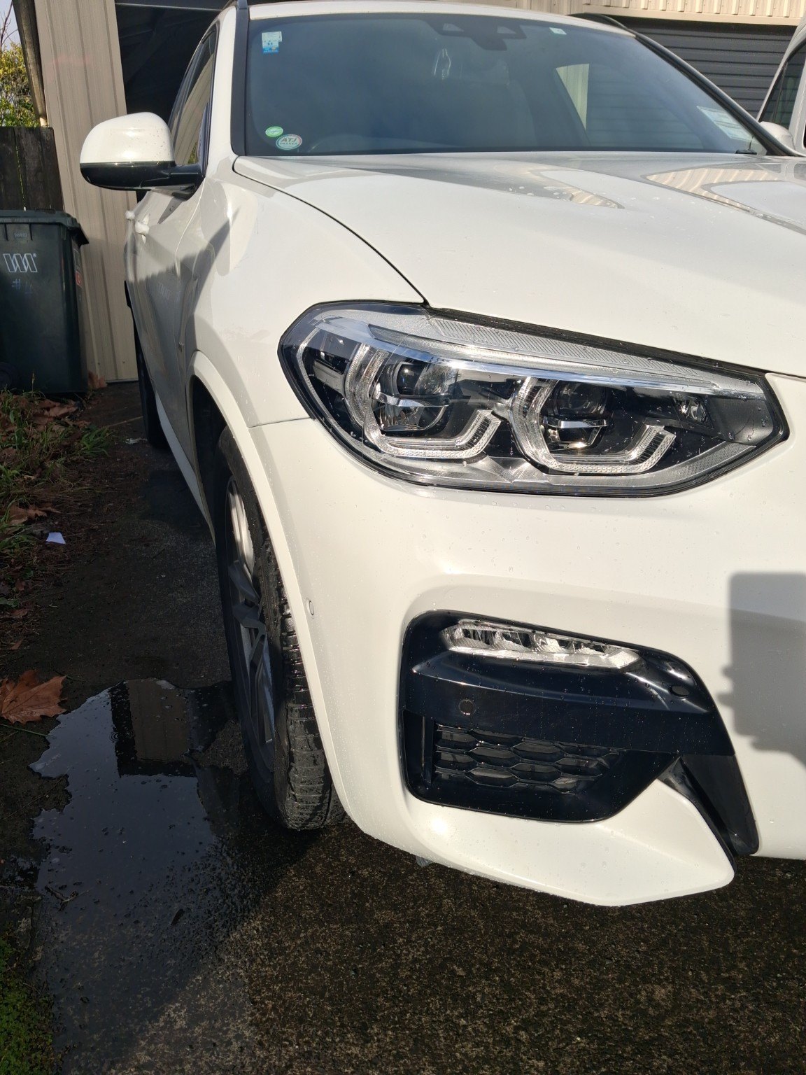 White BMW front corner after panel and paint repair