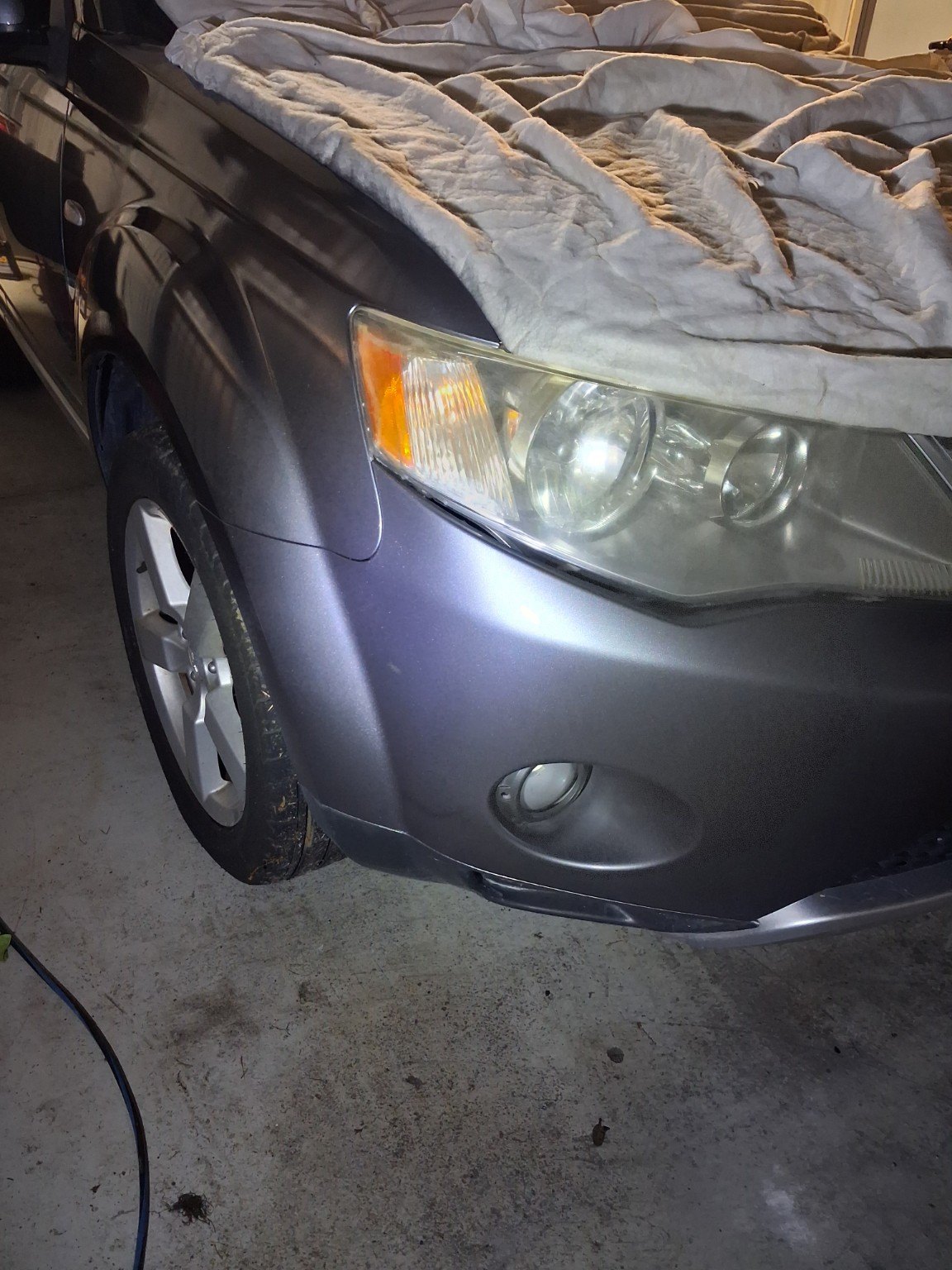 Grey vehicle front corner showing completed panel and paint refinishing