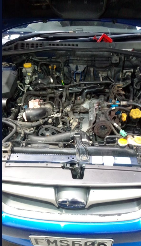 Subaru engine bay during repair work
